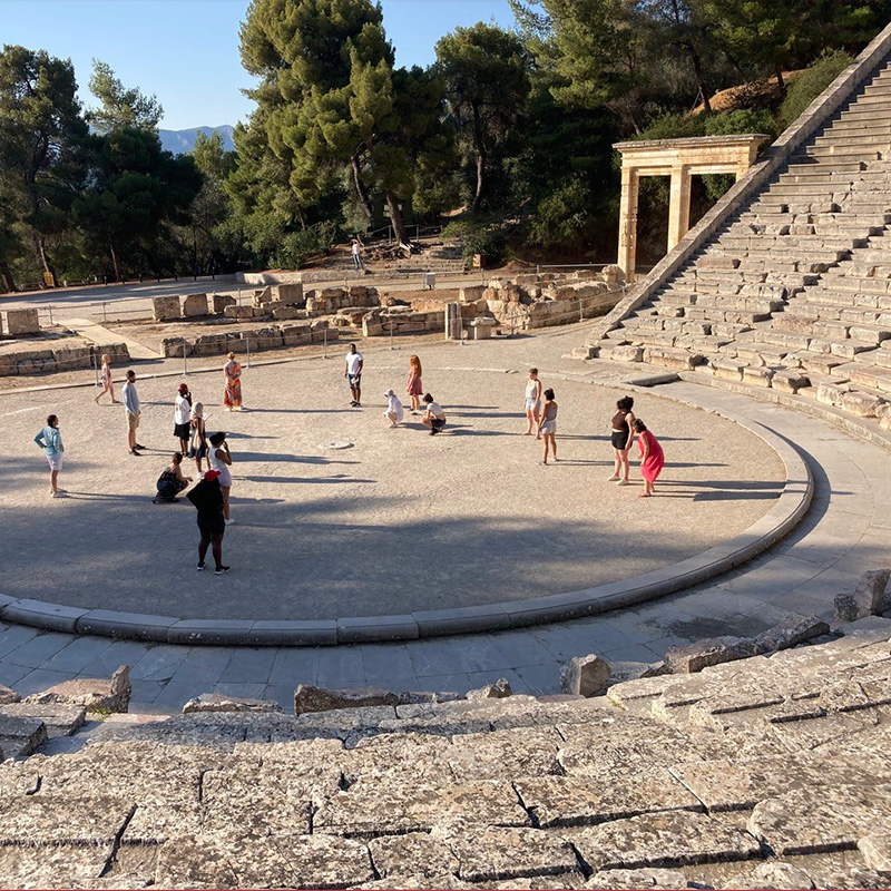 Participants of the 2022 BADA Greek Program Summer School on stage in the ruins of an Ancient greek theatre