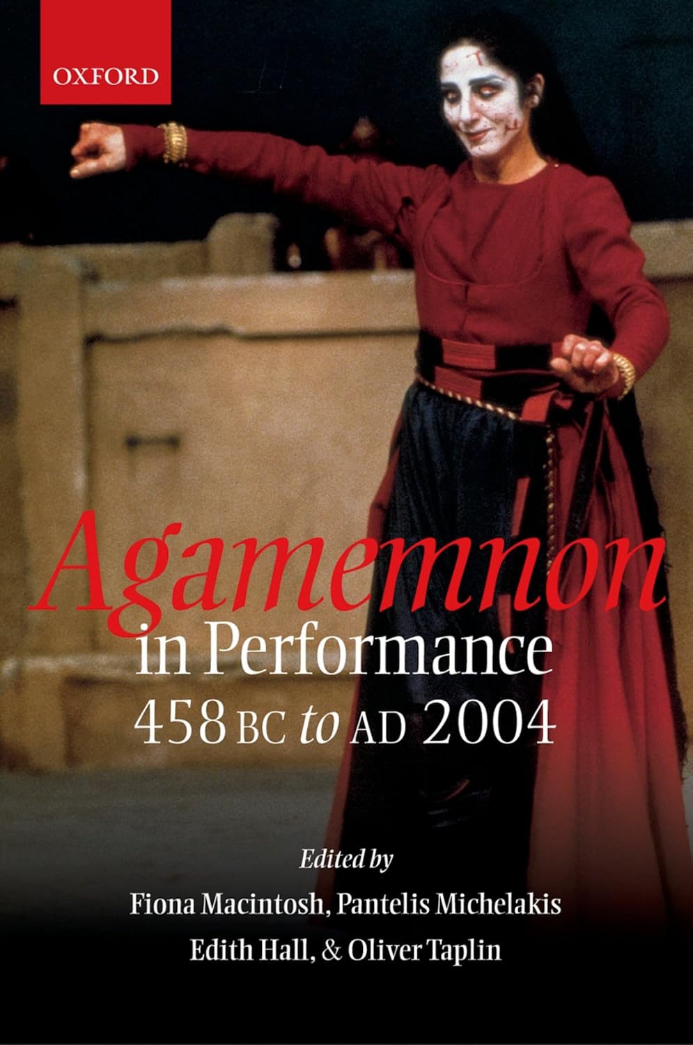 Cover page of 'Agamemnon in Performance', in red and white writing across a photo of an actor holding a red tapestry.
