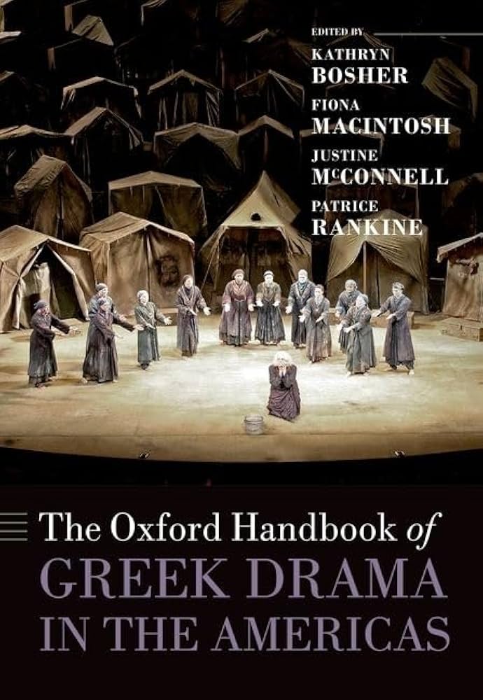 Cover of 'The Oxford Handbook of Greek Drama in the Americas'. The title is written in white and lilac against a black background, below a photo of Hecuba performed at Brooklyn Academy of Music, New York (2005).