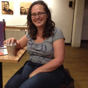 A photo of Helen Eastman sitting at a table, smiling.